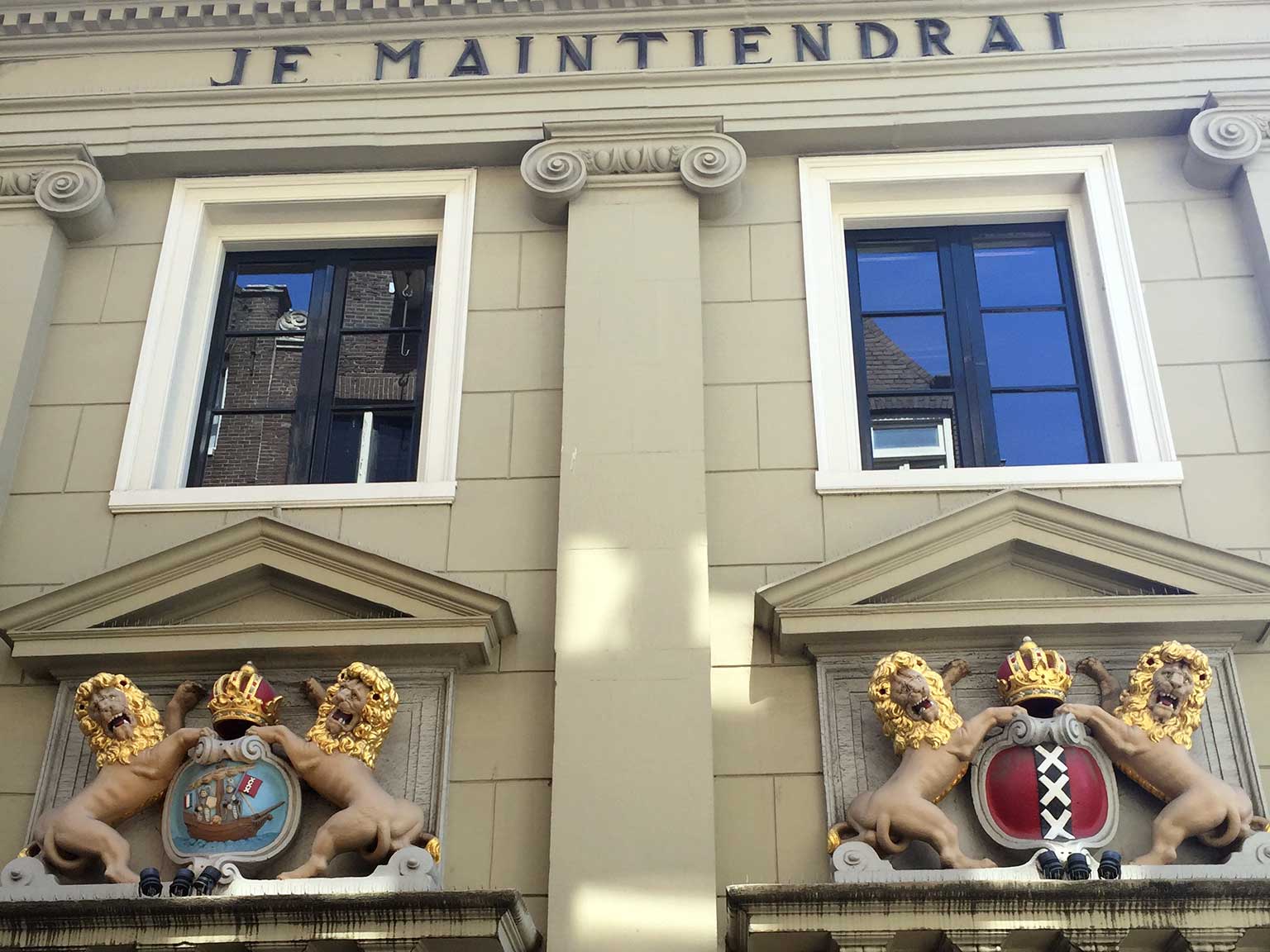 Lions and Amsterdam seals above entrances of the Accijnshuis, Amsterdam