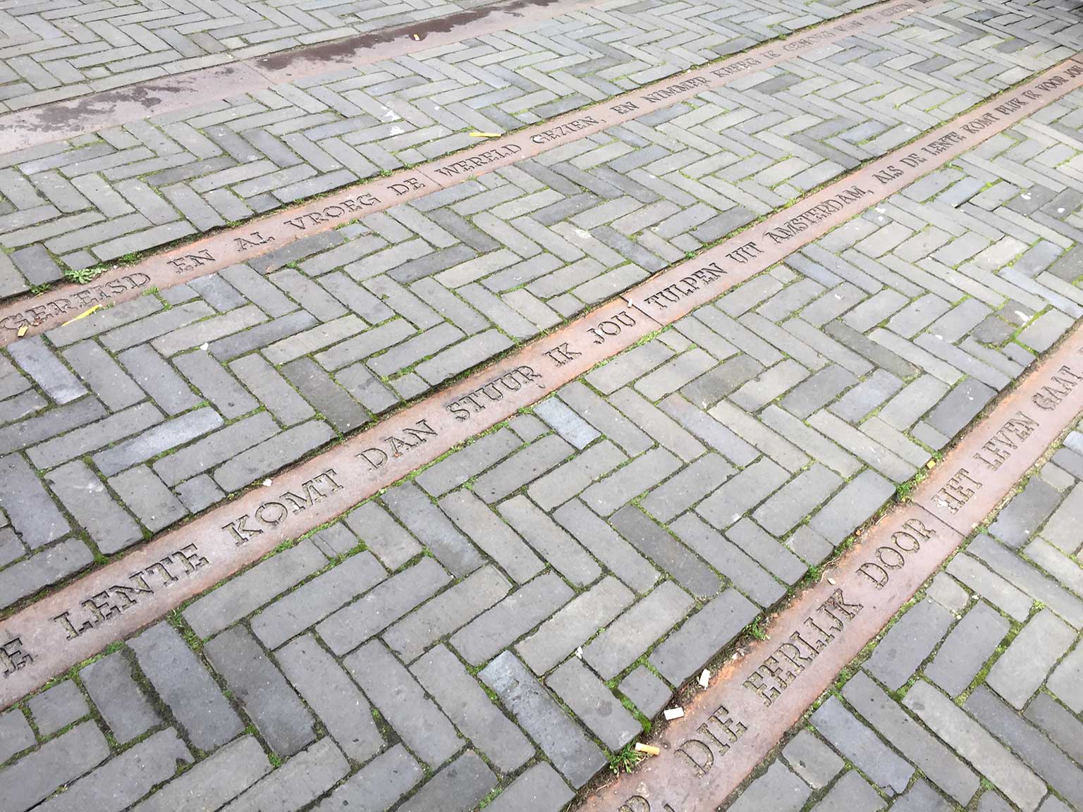 Metal strips with song lyrics in the pavement of the Elandsgracht, Amsterdam