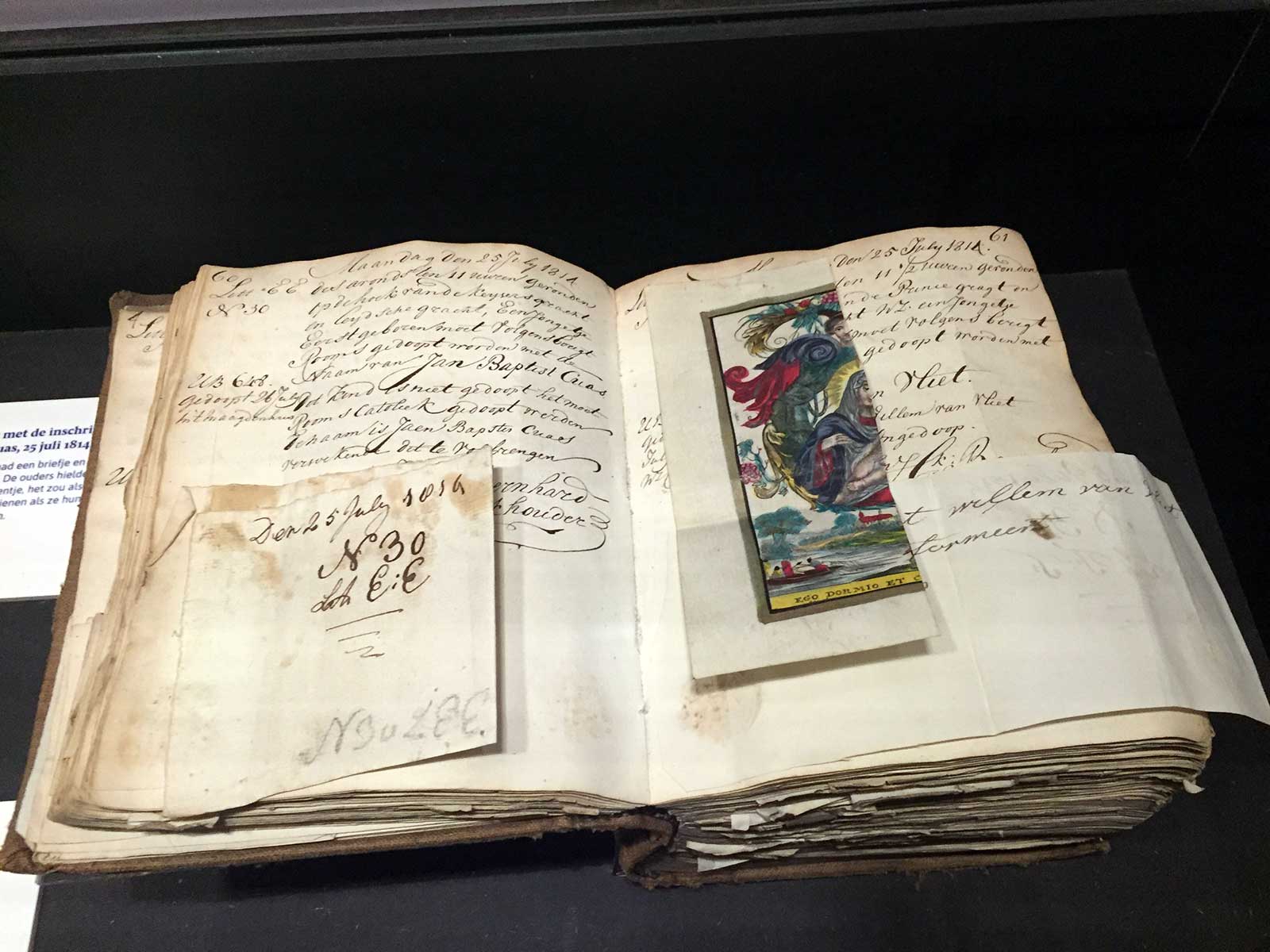 Page in the intake registry of the Aalmoezeniersweeshuis, Amsterdam, with prayer card cut in half