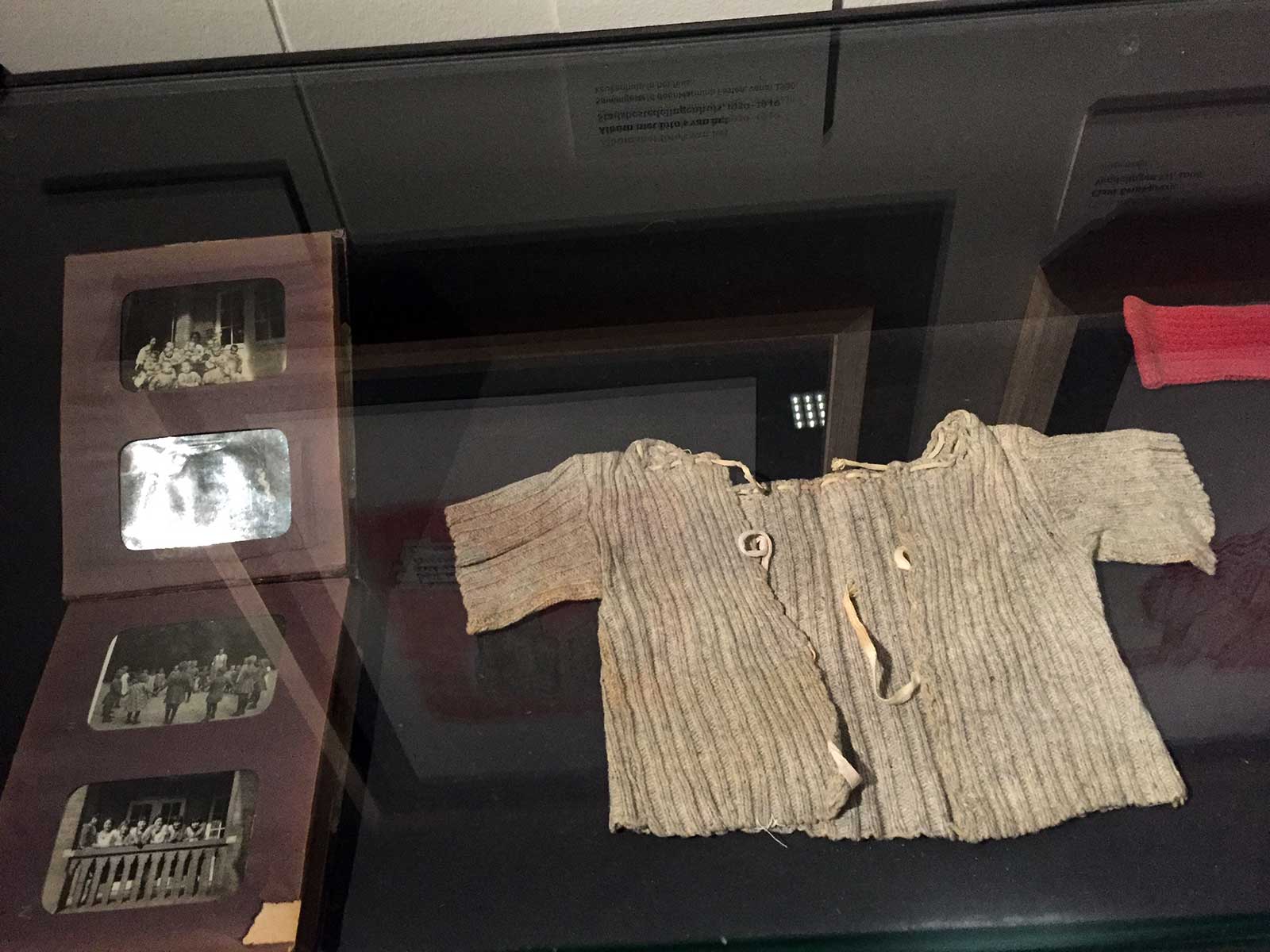 Cardigan of Amsterdam orphan child and old photos on display