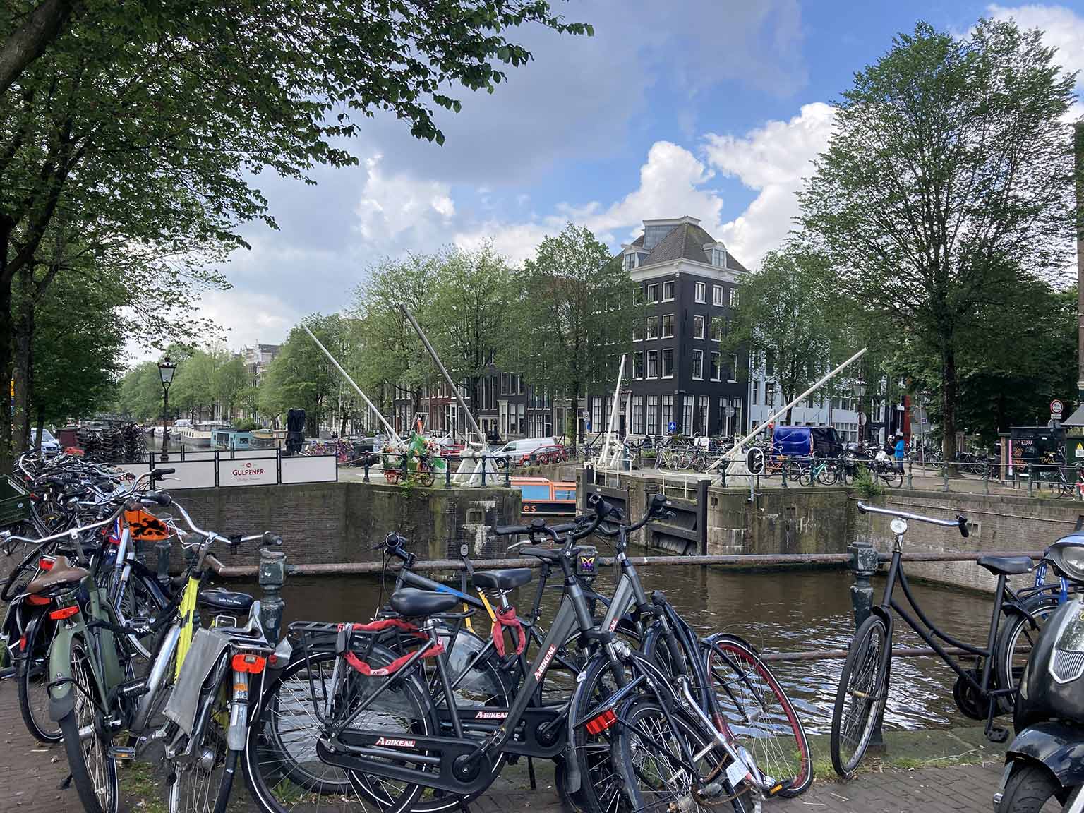 Haarlemmersluis, Amsterdam, looking southwest on Singel, bicycles on the bridge railing