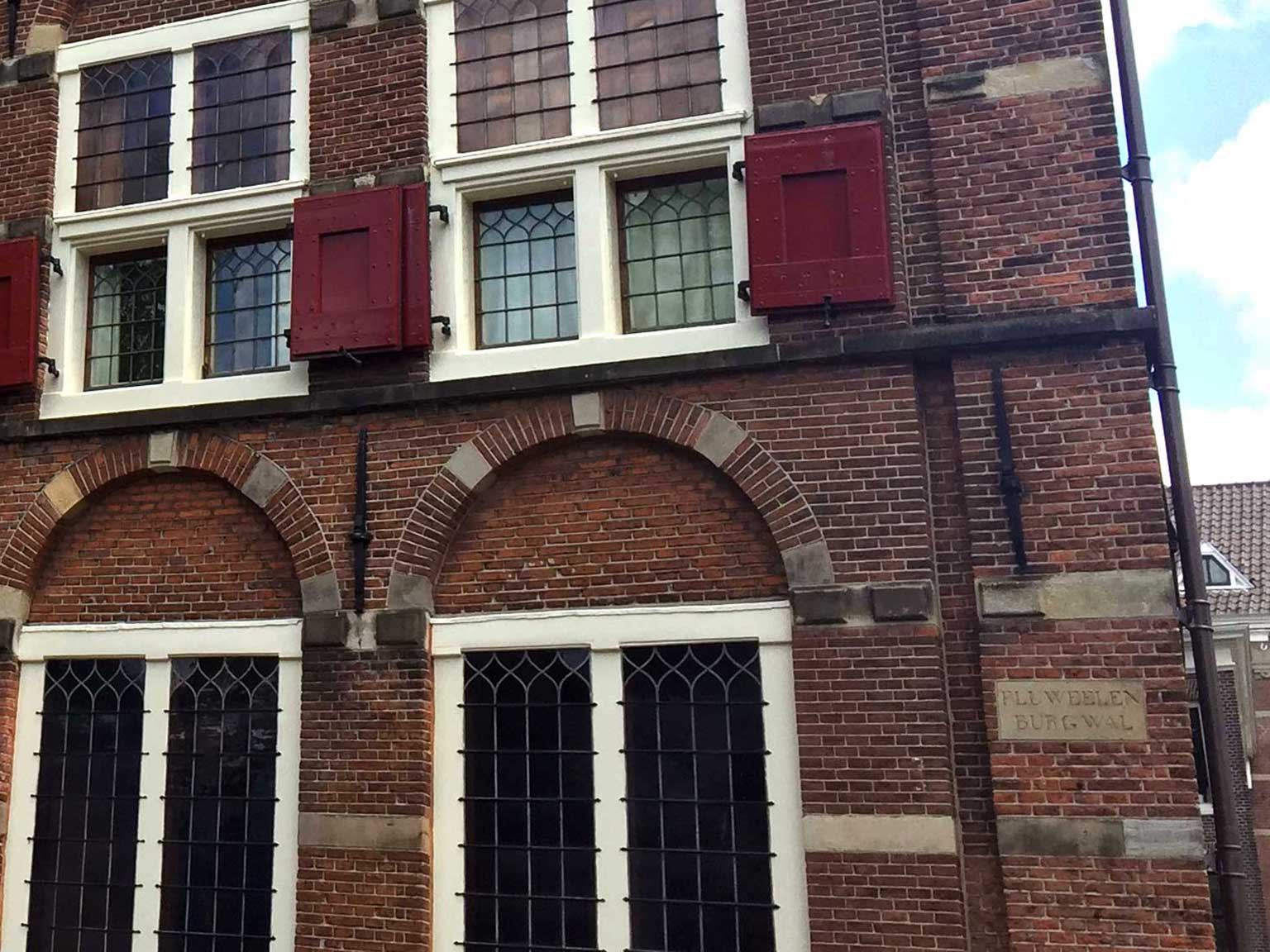 Old streetname sign Fluweelen Burgwal, Oudezijds Voorburgwal, Amsterdam