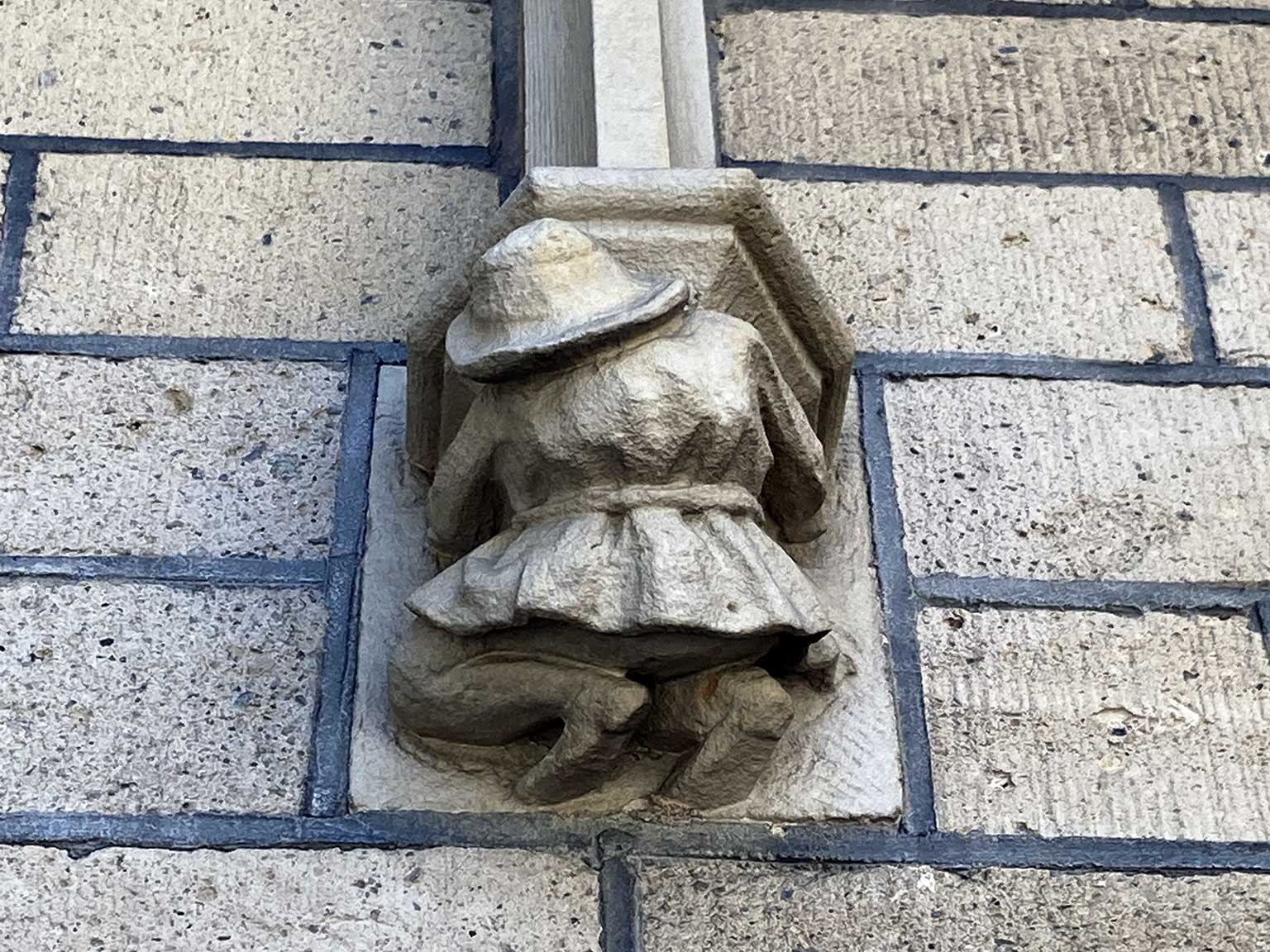 Close-up of a small sculpture on the wall of the Nieuwe Kerk, Mozes en Aäronstraat, Amsterdam