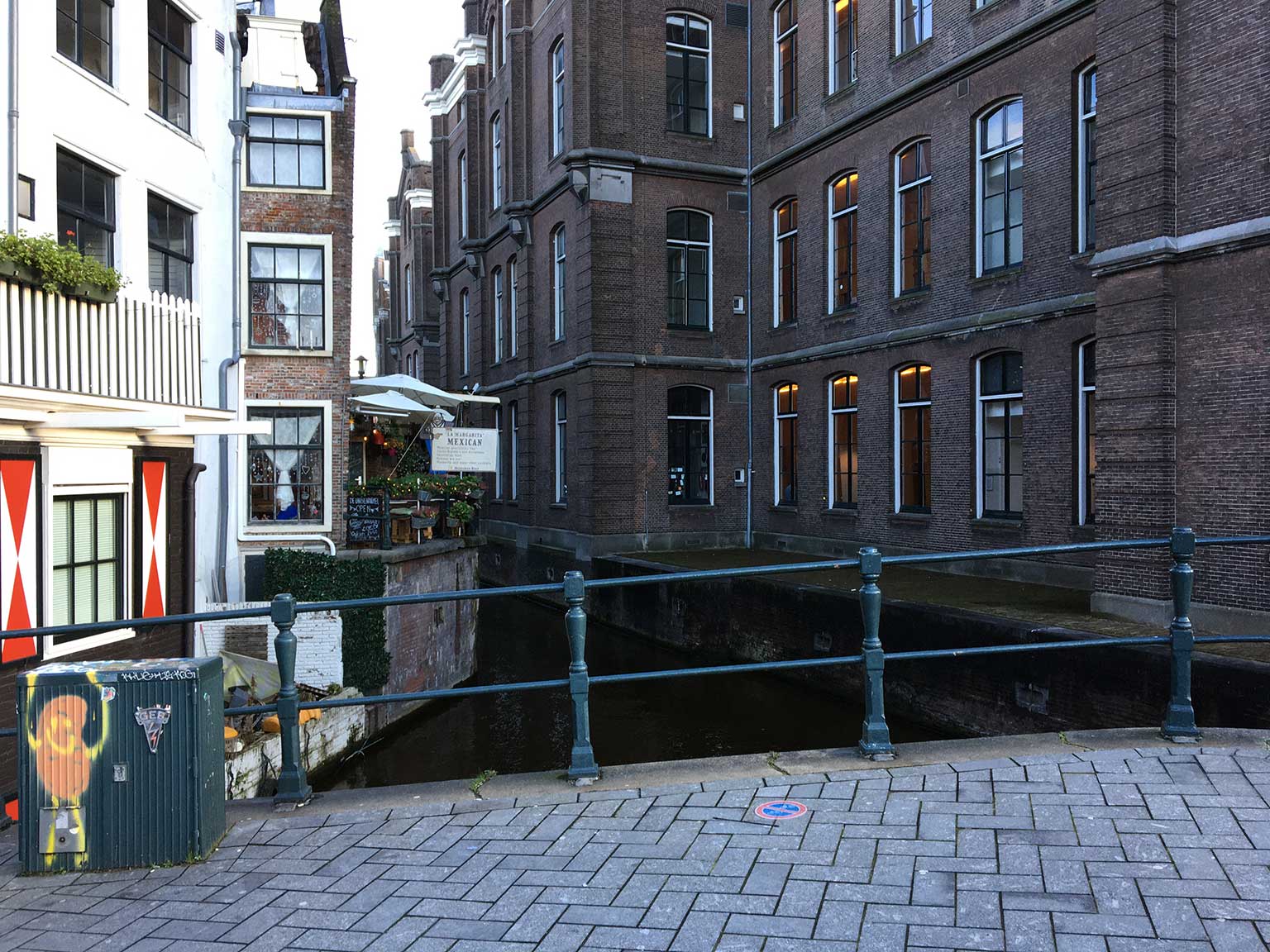 Standing on the bridge Grimnessesluis, Amsterdam, looking down Grimburgwal