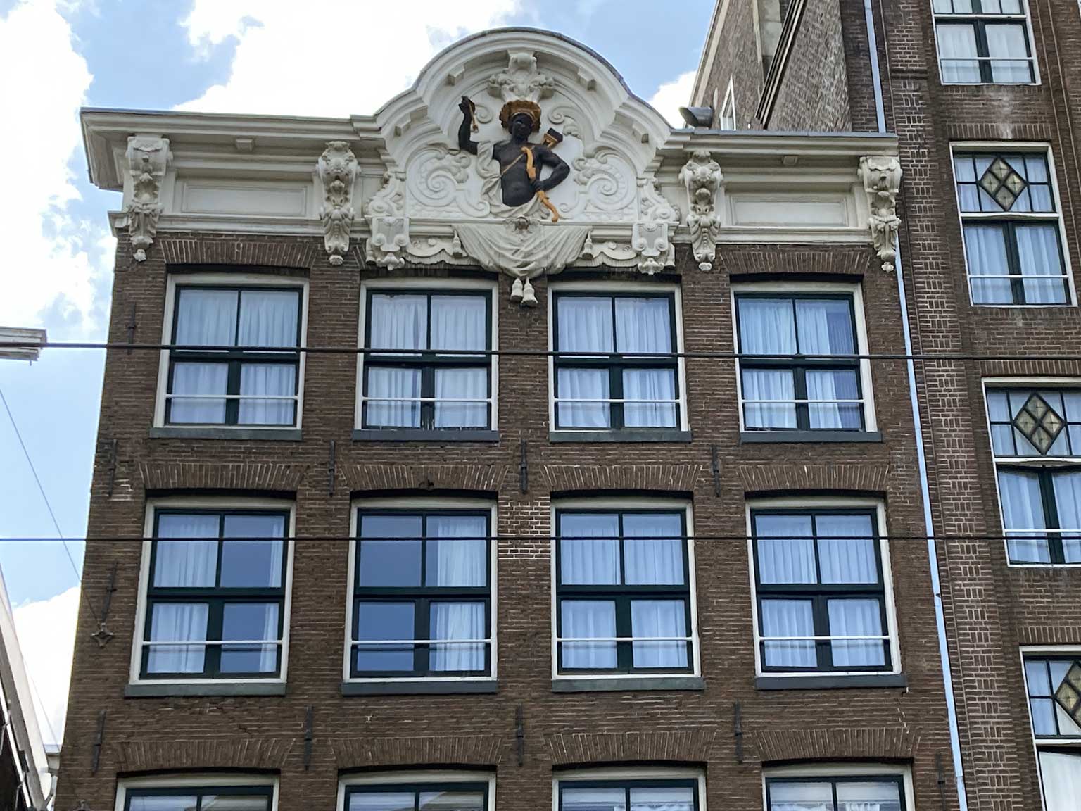 Close-up of the top gable of Rokin 64, Amsterdam, a Moor holding a bow and arrow