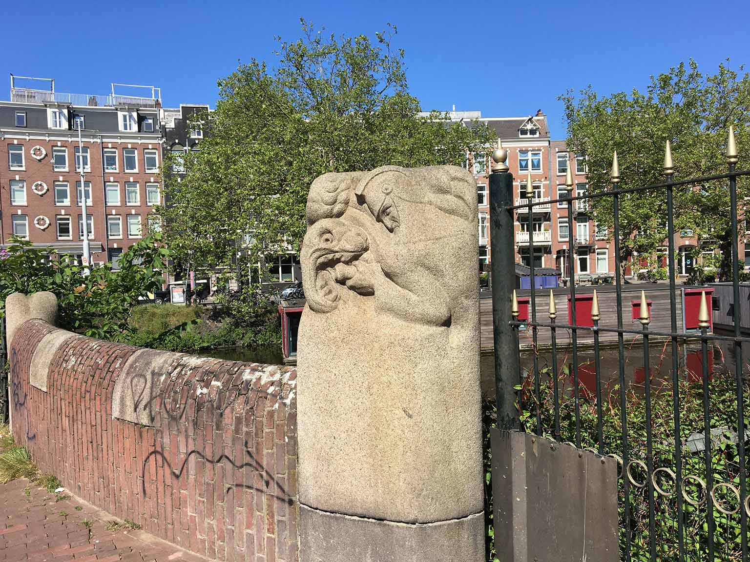 Rijckerbrug, Amsterdam, with statue of fireman battling a fire-breathing dragon