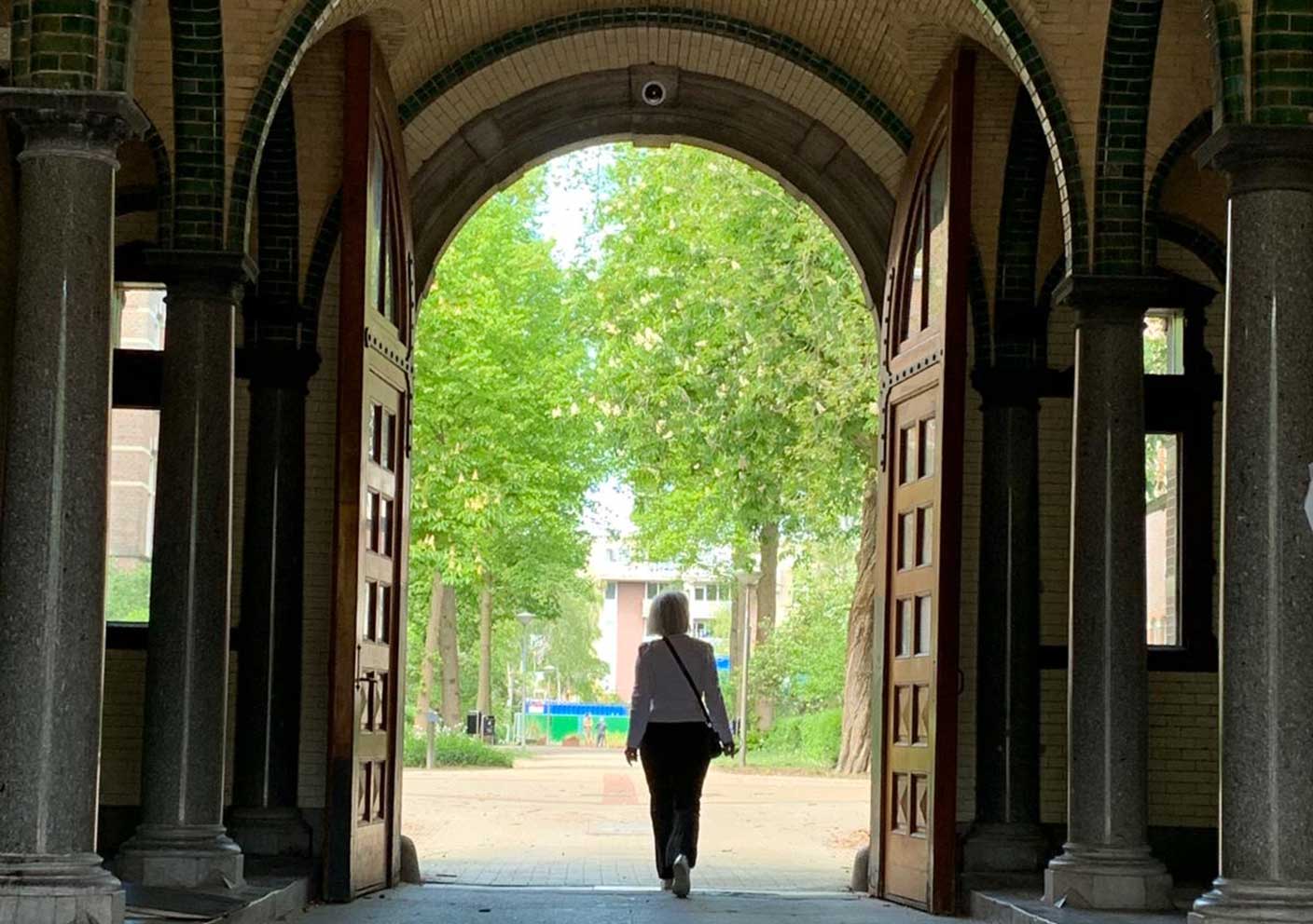 Marjolein walking through a passageway in the former hospital Wilhelmina Gasthuis, Amsterdam